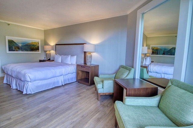 bedroom with wood-type flooring and ornamental molding