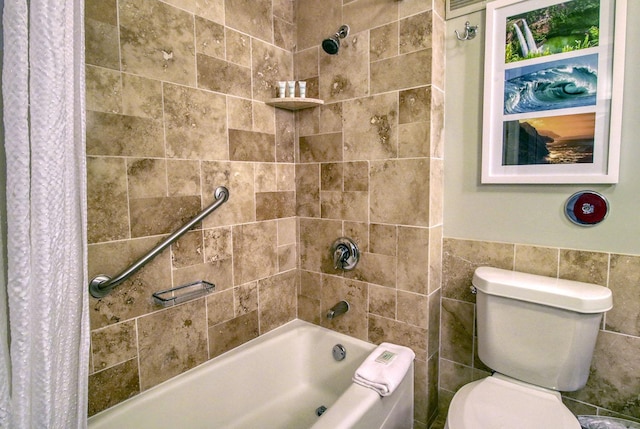 bathroom with shower / tub combo, tile walls, and toilet