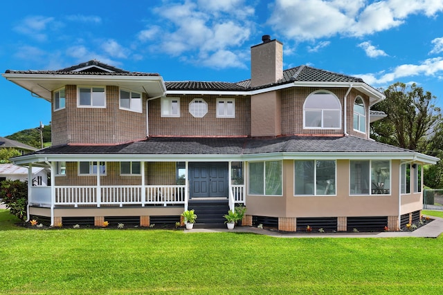 back of house featuring a lawn