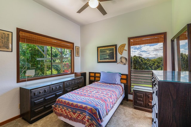 carpeted bedroom with multiple windows and ceiling fan