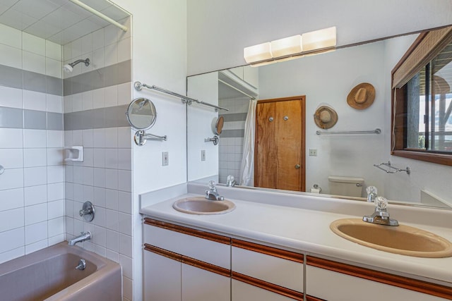 full bathroom with shower / bath combination with curtain, toilet, and vanity