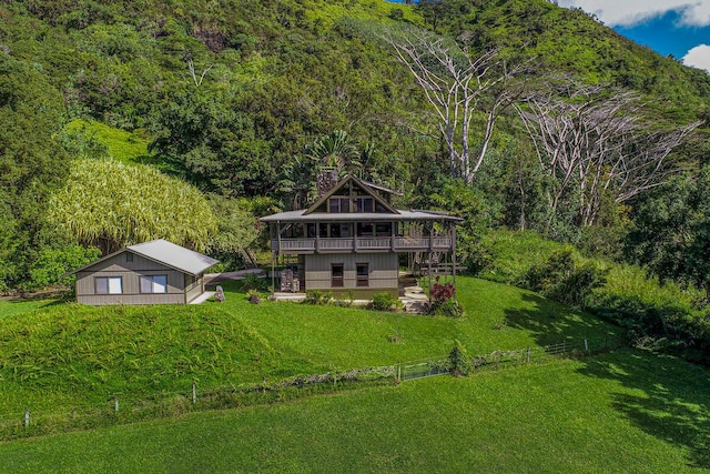 back of property with a yard and a patio