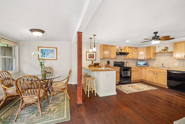 kitchen featuring a breakfast bar, light brown cabinets, dark wood-type flooring, black appliances, and ventilation hood