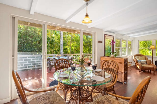 sunroom / solarium featuring a wealth of natural light and beamed ceiling