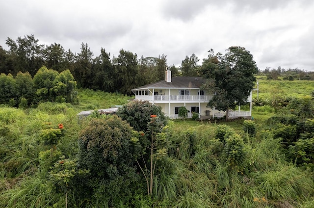 rear view of house featuring a balcony