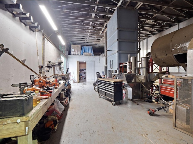 miscellaneous room with a workshop area and concrete floors