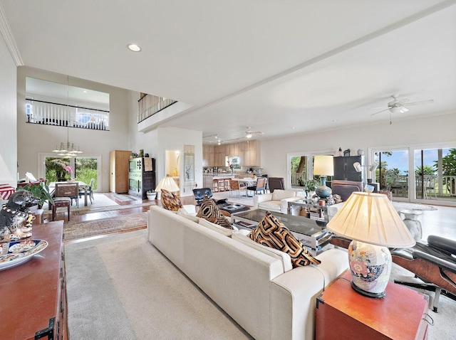 living room featuring ceiling fan and crown molding