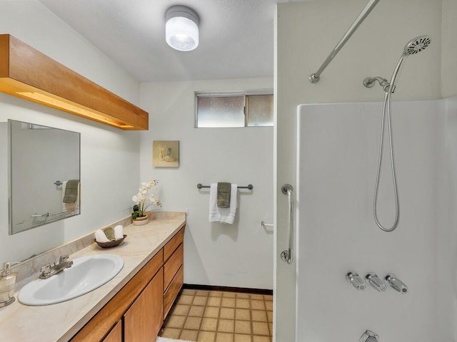 bathroom with a shower and vanity