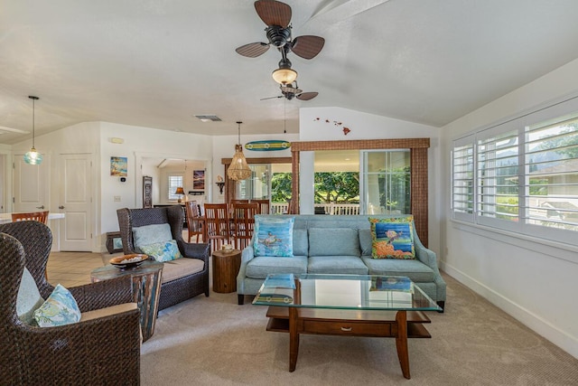 living room with plenty of natural light, light colored carpet, and vaulted ceiling