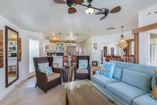 tiled living room featuring ceiling fan and vaulted ceiling