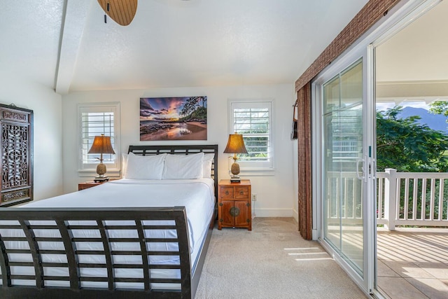 carpeted bedroom with access to outside, multiple windows, a textured ceiling, and beam ceiling