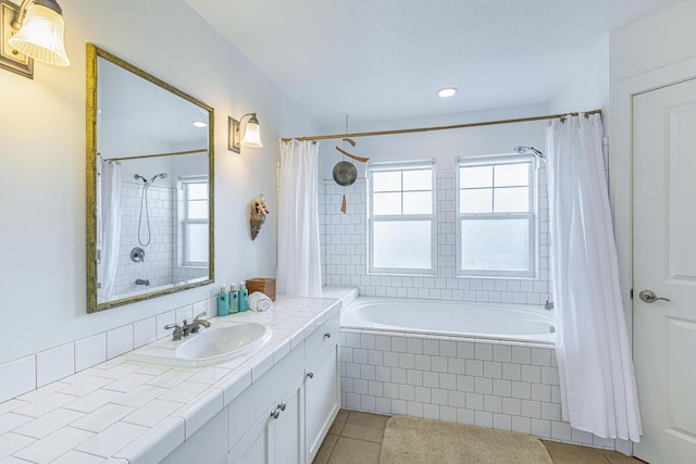 bathroom with tile patterned floors, vanity, and shower / tub combo