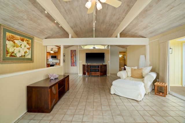 living room with light tile patterned flooring, ceiling fan, beamed ceiling, and wood ceiling