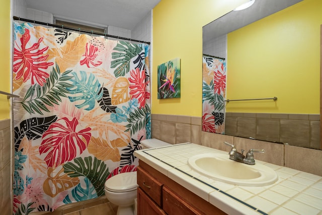 bathroom featuring tile patterned flooring, vanity, and toilet