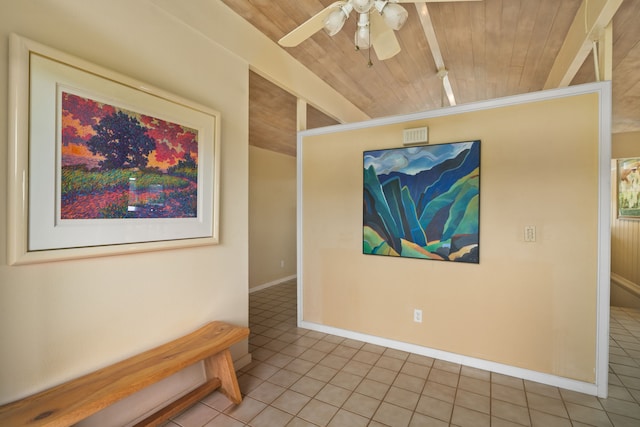 hall with beamed ceiling, light tile patterned floors, and wood ceiling