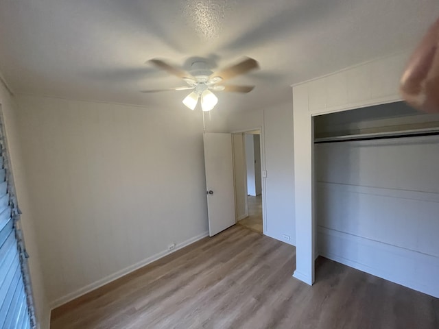 unfurnished bedroom with ceiling fan, a closet, and light hardwood / wood-style floors