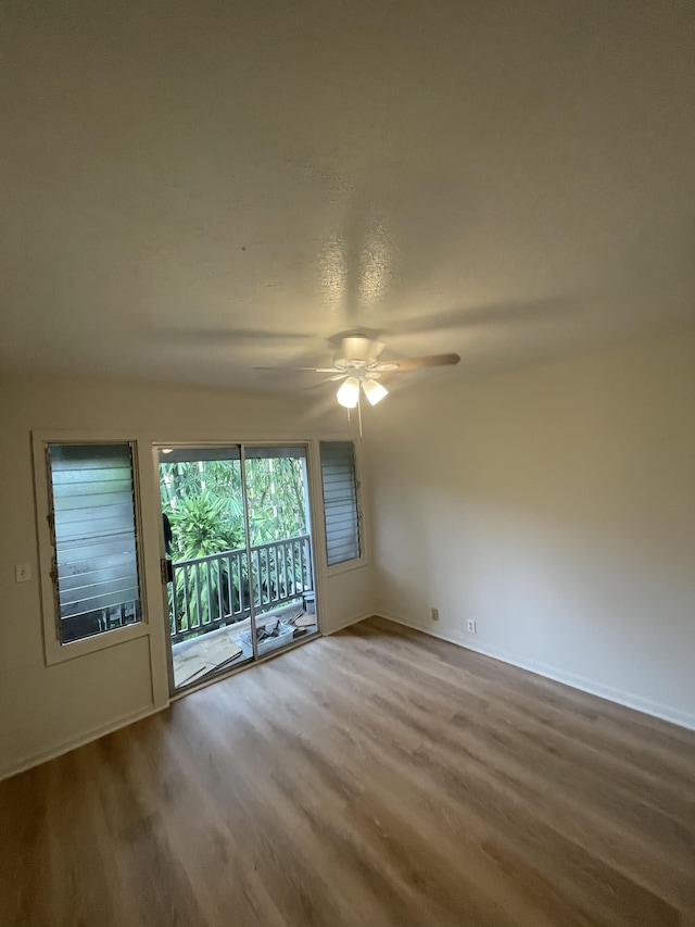 empty room with wood-type flooring and ceiling fan