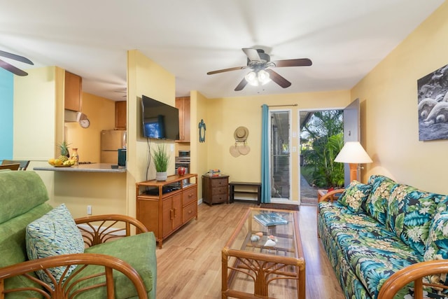 living room featuring ceiling fan and light hardwood / wood-style floors