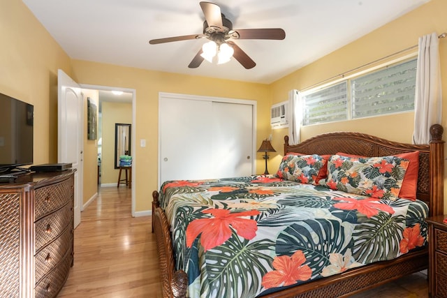 bedroom with ceiling fan, a closet, and light hardwood / wood-style flooring