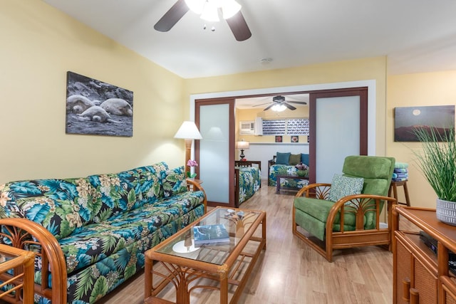 living room featuring light hardwood / wood-style floors and ceiling fan