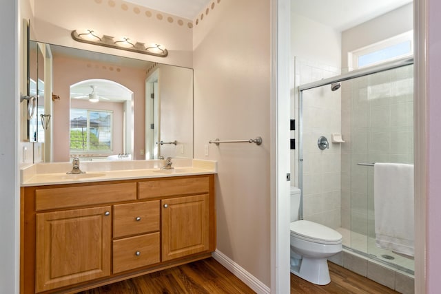 bathroom featuring hardwood / wood-style flooring, toilet, and a wealth of natural light