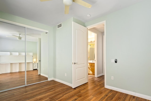 unfurnished bedroom featuring a closet, ceiling fan, and dark hardwood / wood-style floors