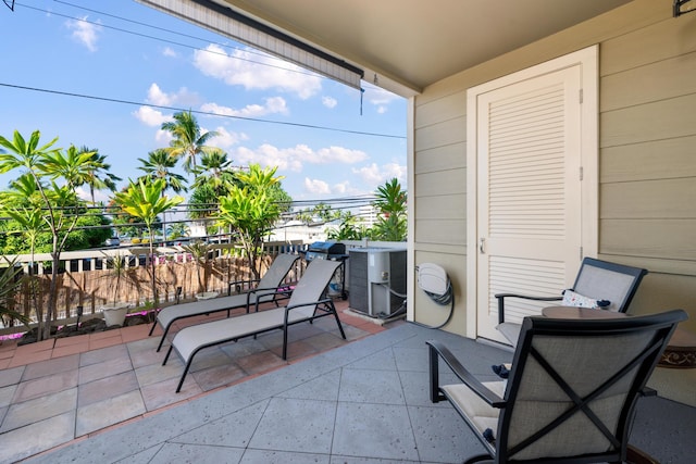 balcony featuring central air condition unit and a patio