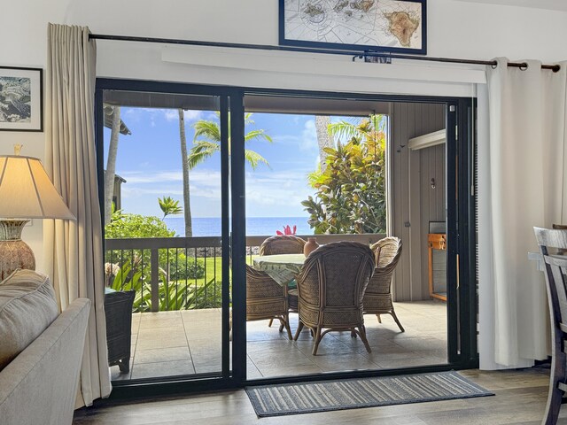 doorway featuring a water view and light hardwood / wood-style floors