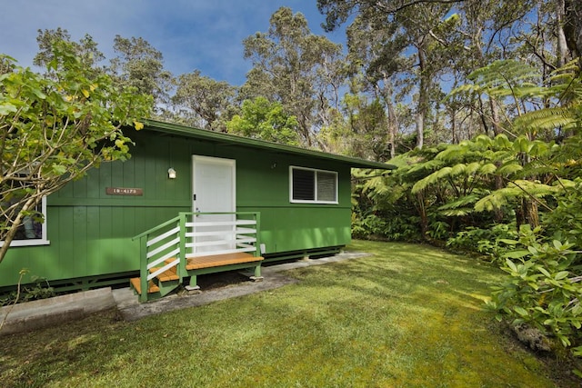 view of outbuilding featuring a lawn