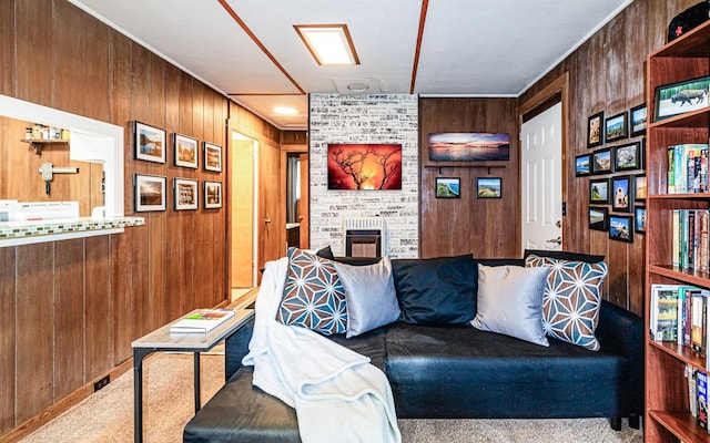 living room with carpet flooring, wood walls, ornamental molding, and a fireplace