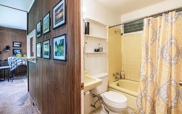 bathroom with shower / bath combo, toilet, and wooden walls