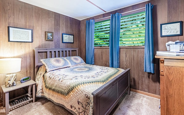 carpeted bedroom with wood walls