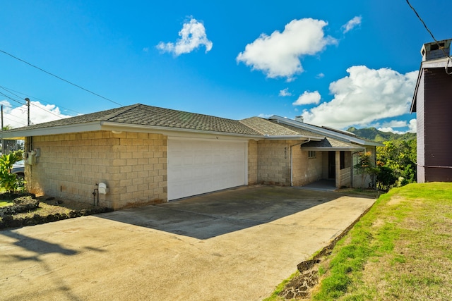 view of front of property with a front yard and a garage