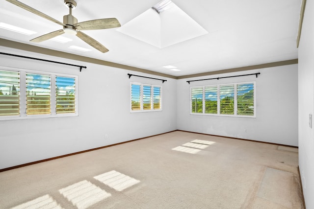 carpeted empty room with plenty of natural light and ceiling fan