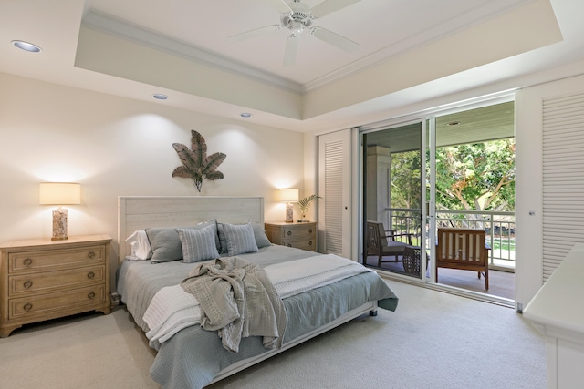 carpeted bedroom with ornamental molding, access to outside, ceiling fan, and a tray ceiling