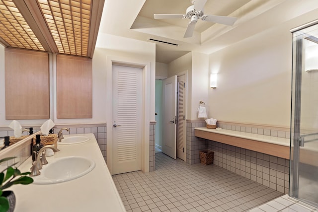 bathroom with tile patterned floors, vanity, ceiling fan, and tile walls