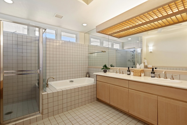 bathroom with tile patterned floors, vanity, and plus walk in shower