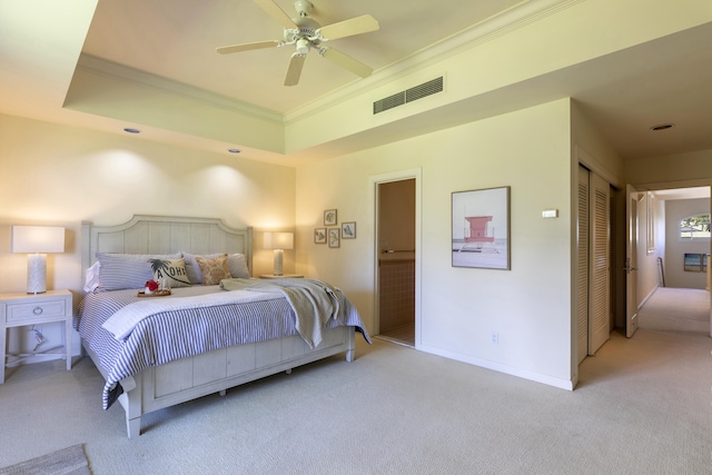 bedroom featuring a closet, light carpet, crown molding, and ceiling fan