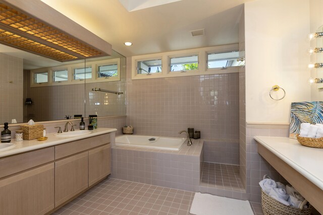 bathroom with tile patterned floors, separate shower and tub, and vanity