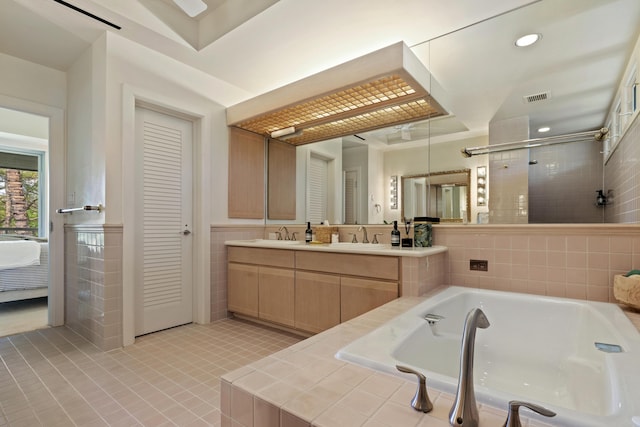 bathroom with plus walk in shower, vanity, and tile patterned floors