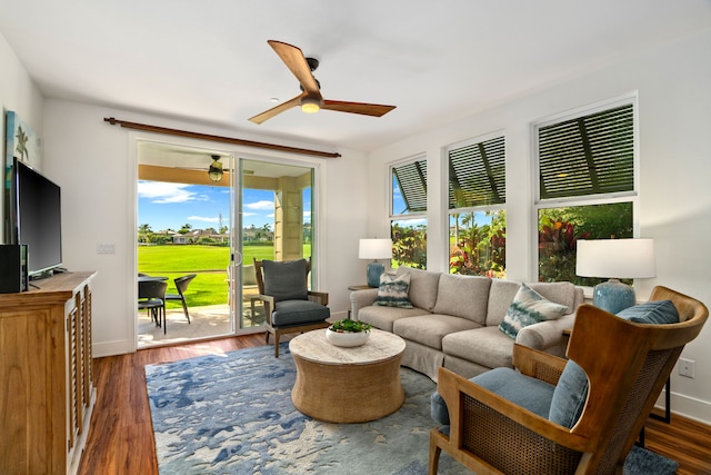 living room featuring dark hardwood / wood-style floors and ceiling fan