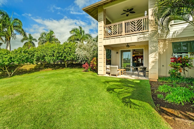 view of yard featuring ceiling fan, a patio area, and a balcony