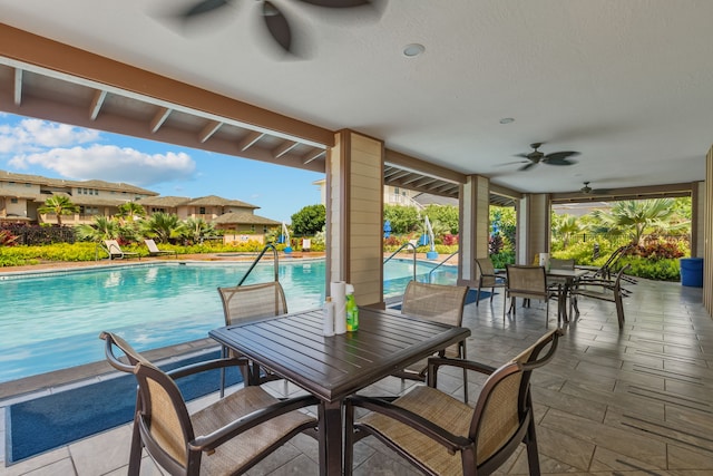 view of pool with ceiling fan and a patio area