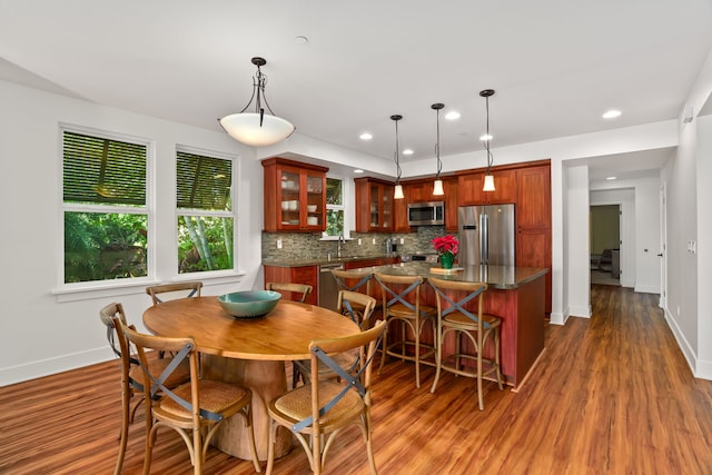 dining space featuring dark hardwood / wood-style floors and sink