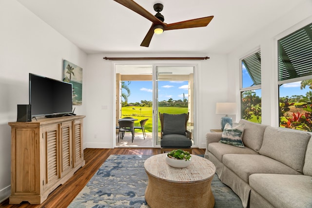 living room with dark hardwood / wood-style floors and ceiling fan