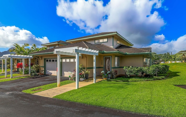 view of front of home featuring a garage and a front lawn