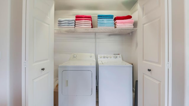 clothes washing area with separate washer and dryer