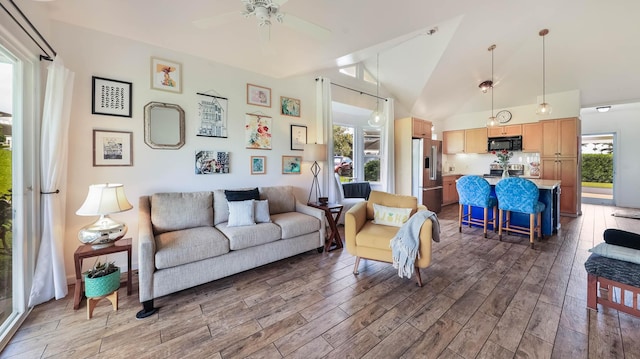 living room with ceiling fan and lofted ceiling