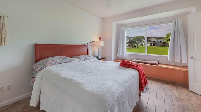 bedroom with hardwood / wood-style floors and ceiling fan