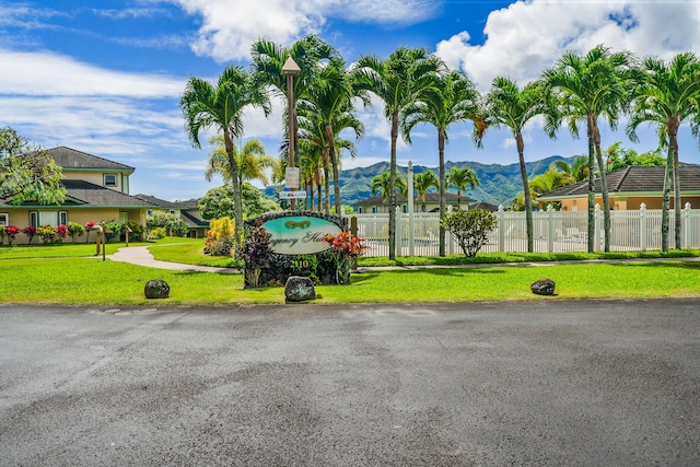 view of property's community with a mountain view and a yard